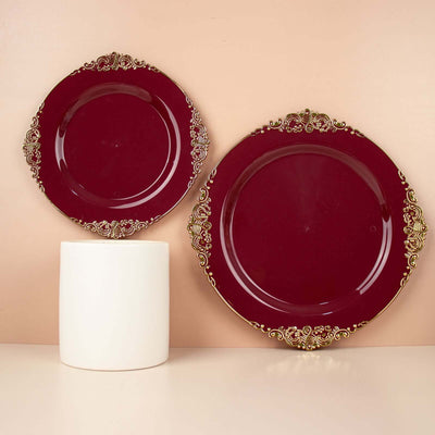 Elegant burgundy plates with gold detailing on a neutral background.