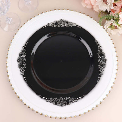 Elegant black decorative plate with intricate white detailing.