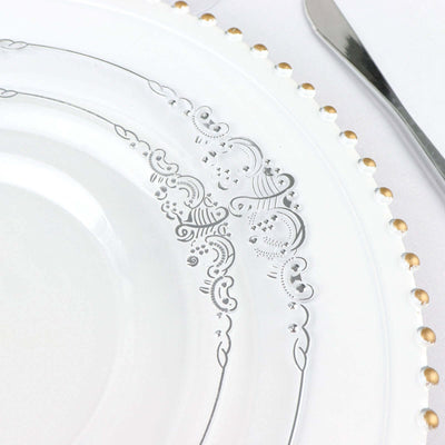 Elegant white plate with intricate silver and gold detailing.