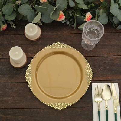 Elegant gold charger plate with ornate design on a rustic wooden table.