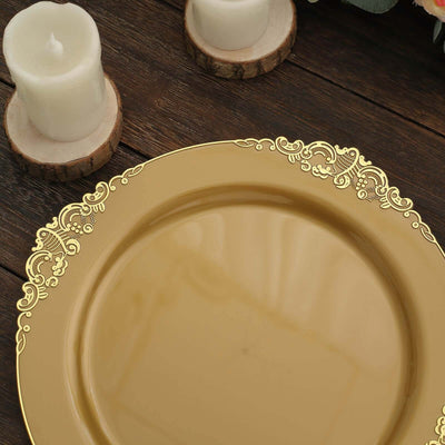 Gold decorative plate with ornate design on a wooden table.