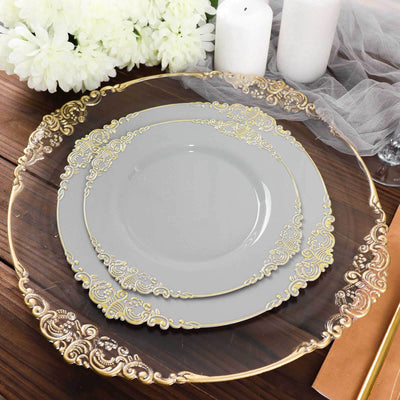 Elegant grey plates with gold detailing on a wooden table setting.