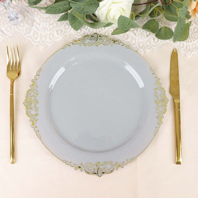 Elegant gold-trimmed plate with fork and knife, styled on a soft table setting.