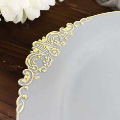 Elegant gray plate with gold decorative rim on a wooden surface.