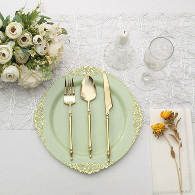 Elegant gold-plated cutlery set on a mint green plate with floral arrangement
