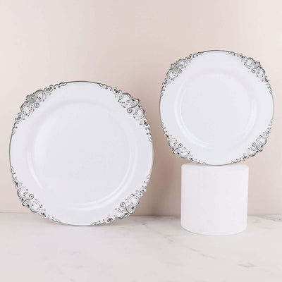 Elegant white plates with intricate silver detailing on a neutral background.