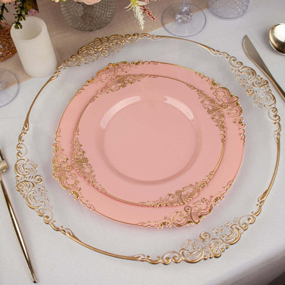 Elegant pink plates with gold ornate detailing on a table setting.
