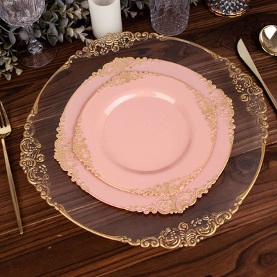 Elegant pink plates with gold accents on a wooden table setting.