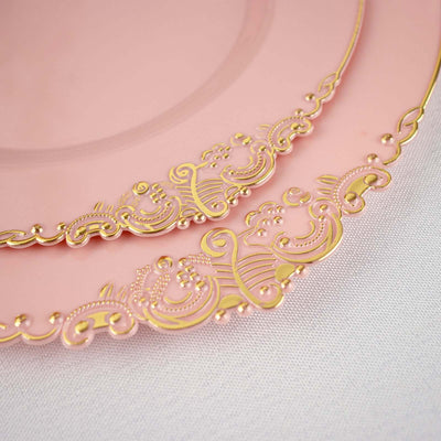 Pink decorative plates with intricate gold detailing.