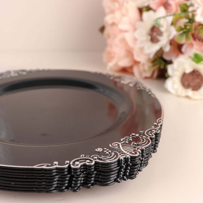 Elegant black decorative plate with intricate silver detailing.