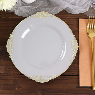 Elegant gray plate with gold detailing on a rustic wooden table setting.
