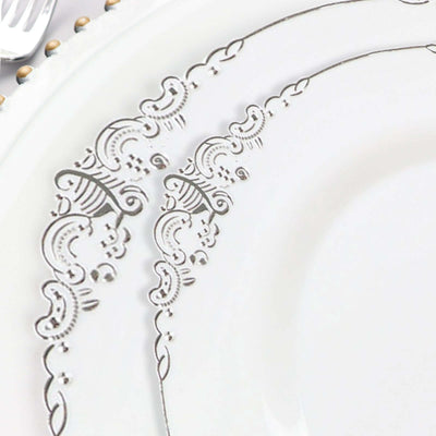 Elegant white plate with intricate silver floral design.