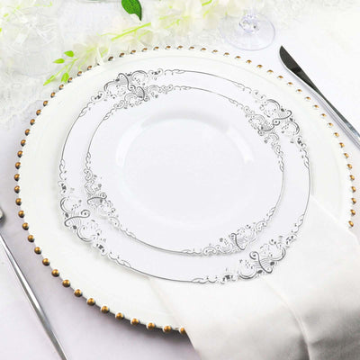 Elegant white dinner plates with silver filigree design, styled for a refined table setting.