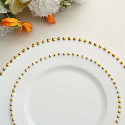 Elegant white plate with gold beaded trim and floral accents.