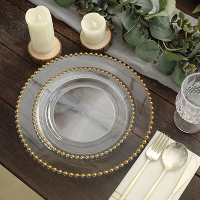 Elegant clear glass plate with gold beaded rim, styled for a table setting.