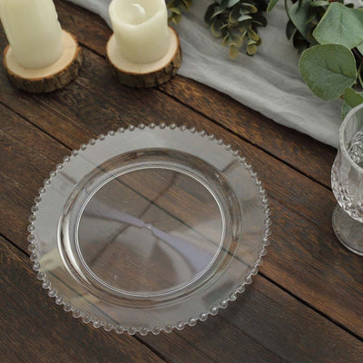 Clear glass plate with beaded edges on a rustic wooden table.
