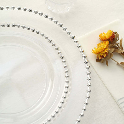 Clear glass plate with beaded edge, styled with dried flowers.