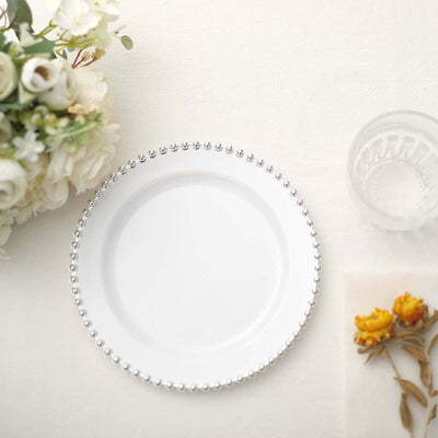 White plate with silver beaded edge on a soft cream backdrop.