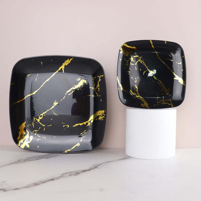 Black square plates with gold marbling design, stylish and modern for dining.