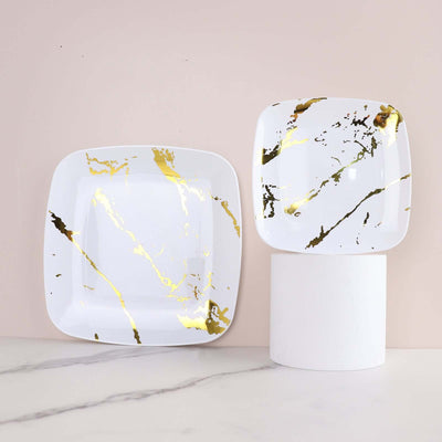 Square ceramic plates with gold and black marble design on a light background.