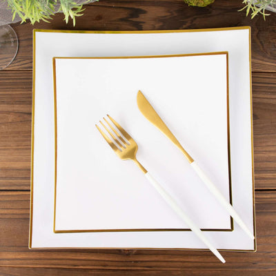 Elegant white dinnerware set with gold trim and matching cutlery.