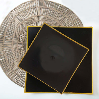Black square serving tray with gold trim on a round woven placemat.