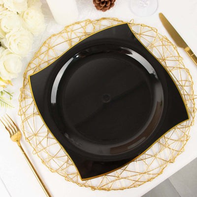 Black decorative plate on a gold wire charger with floral accents.