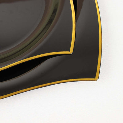 Elegant black plates with golden edges, perfect for dining.