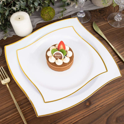 Elegant dessert on a white plate with gold trim, garnished with fresh fruit.
