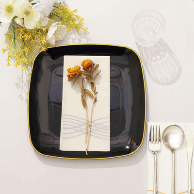 Elegant black plate with napkin and dried flowers, styled for dining decor.