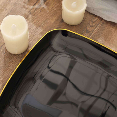 Black square plate with yellow trim, surrounded by white candles.