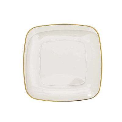 Square white plate with gold rim on a plain background