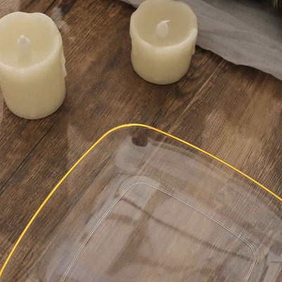 Clear glass plate with a yellow rim, surrounded by candles on a wooden surface.