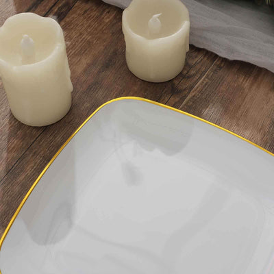 Elegant white plate with gold trim, surrounded by decorative candles.