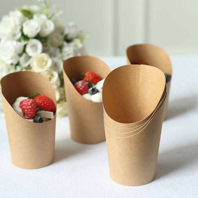 Eco-friendly paper cups filled with fresh berries and cream, stacked together.