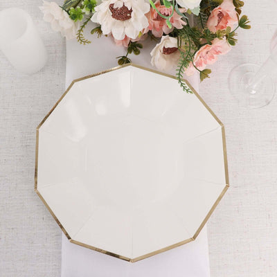 White octagonal plate with gold trim on a soft fabric background.