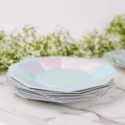 Iridescent octagonal plates stacked on a marble surface with greenery.