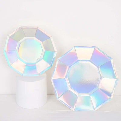 Iridescent geometric plates on a white backdrop