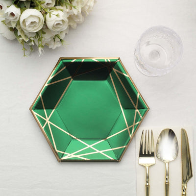 Green hexagon plate with gold geometric design and elegant cutlery.
