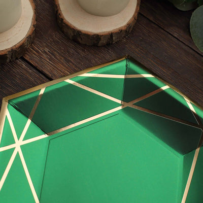 Green geometric decorative tray with gold accents on a wooden surface.