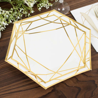 Gold geometric design plate on a wooden table with floral accents.