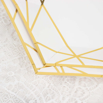 Gold geometric trim paper plate set on lace tablecloth.