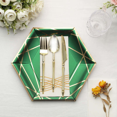Hexagon-shaped green plate with gold accents and elegant cutlery