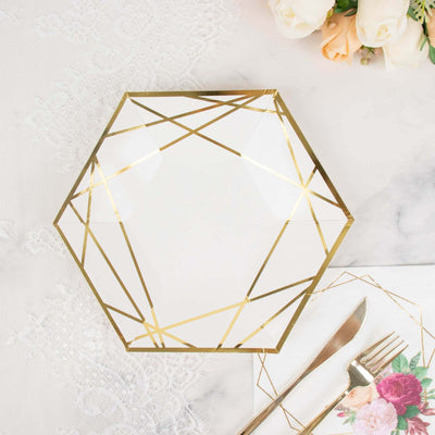 Geometric glass plate with gold accents on a marble table setting.