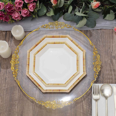 Elegant octagonal white plates with golden rim on a decorative table setting.