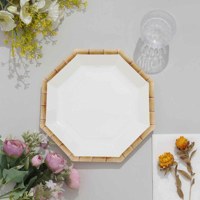 Octagonal white plate with bamboo design on a gray surface.