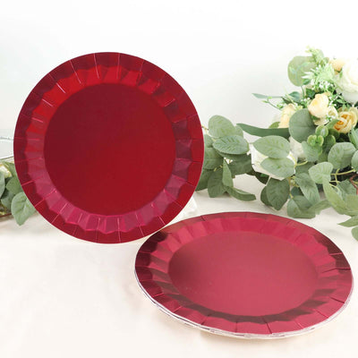 Red disposable plates with scalloped edges, perfect for parties and events.