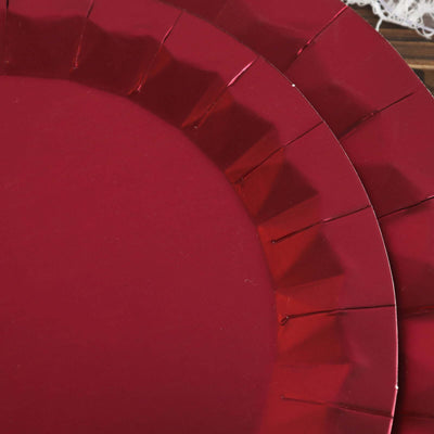 Red paper plates stacked together on a rustic wooden surface.