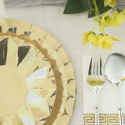 Gold decorative plate with silver cutlery and yellow flowers on a table setting.