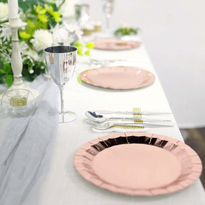 Elegant pink and silver dinnerware set on a beautifully arranged table.